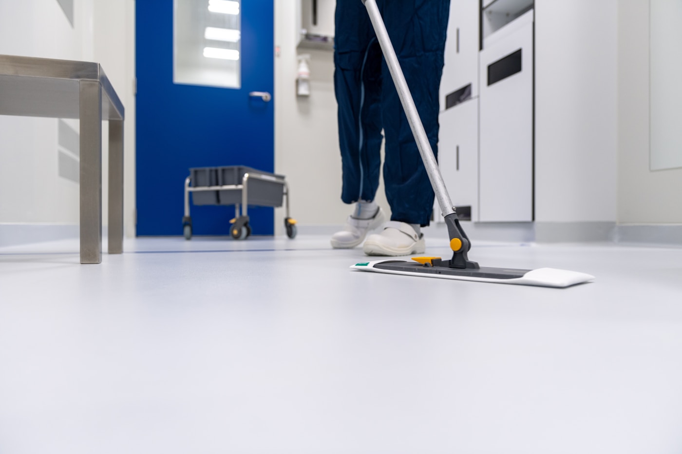 A janitorial professional mopping a clean commercial floor